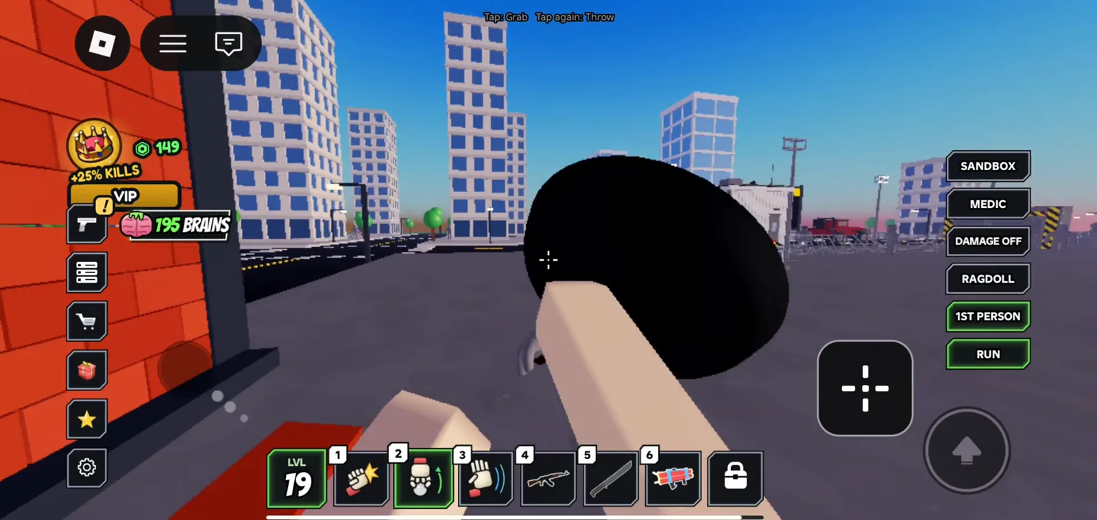 Ragdoll Reality mobile HUD reads tap to grab and tap again to throw while the player holds a large black sphere on an outdoor city block with the sandbox sidebar visible.